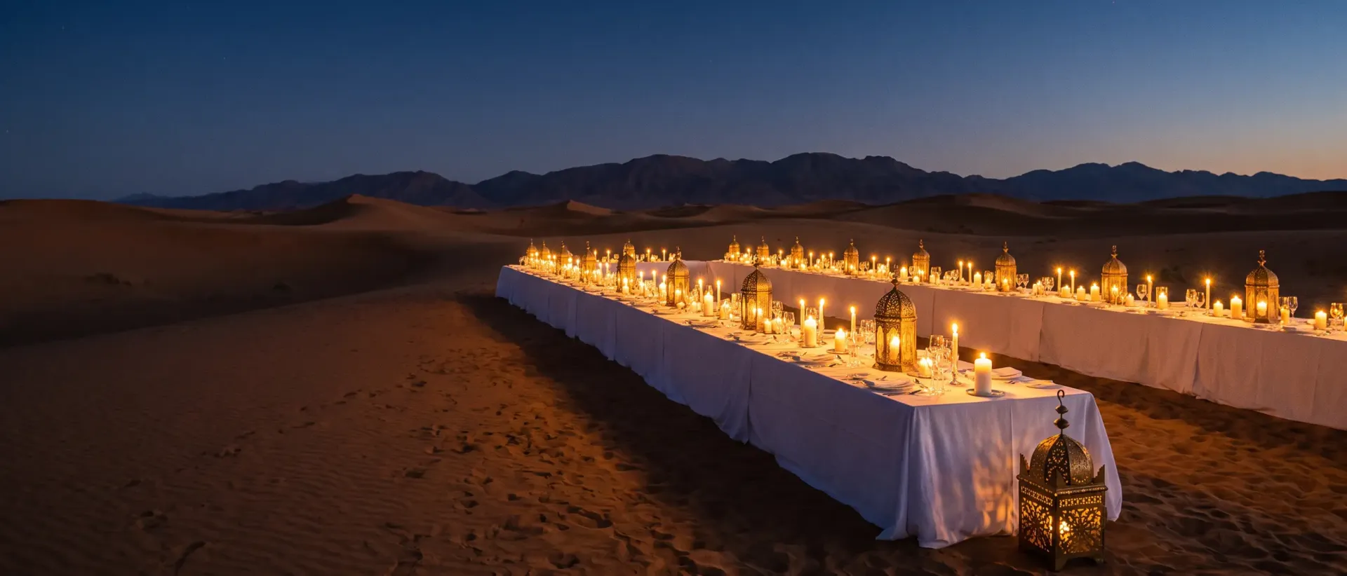 Luxury desert camp in Morocco at twilight with ornate lanterns
