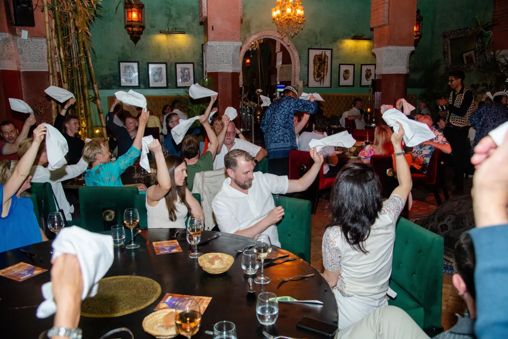 Happy international clients celebrating a vibrant DMC gala event and celebration dinner in Morocco with No Limits Travel & DMC